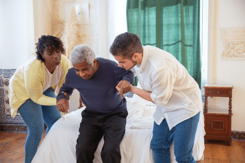 an elderly man getting out of bed