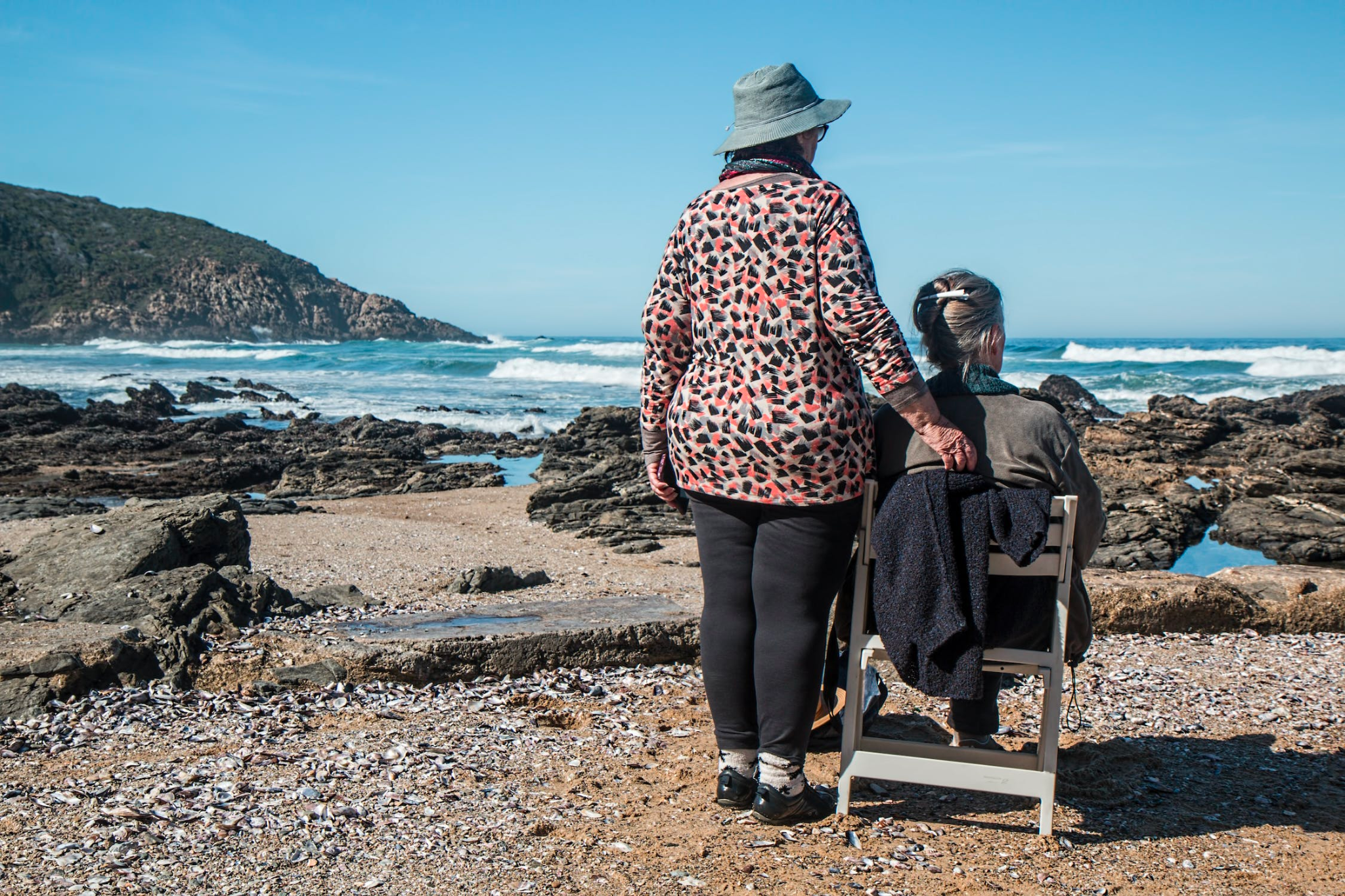  A caregiver accompanies an elderly client on an outdoor excursion. 