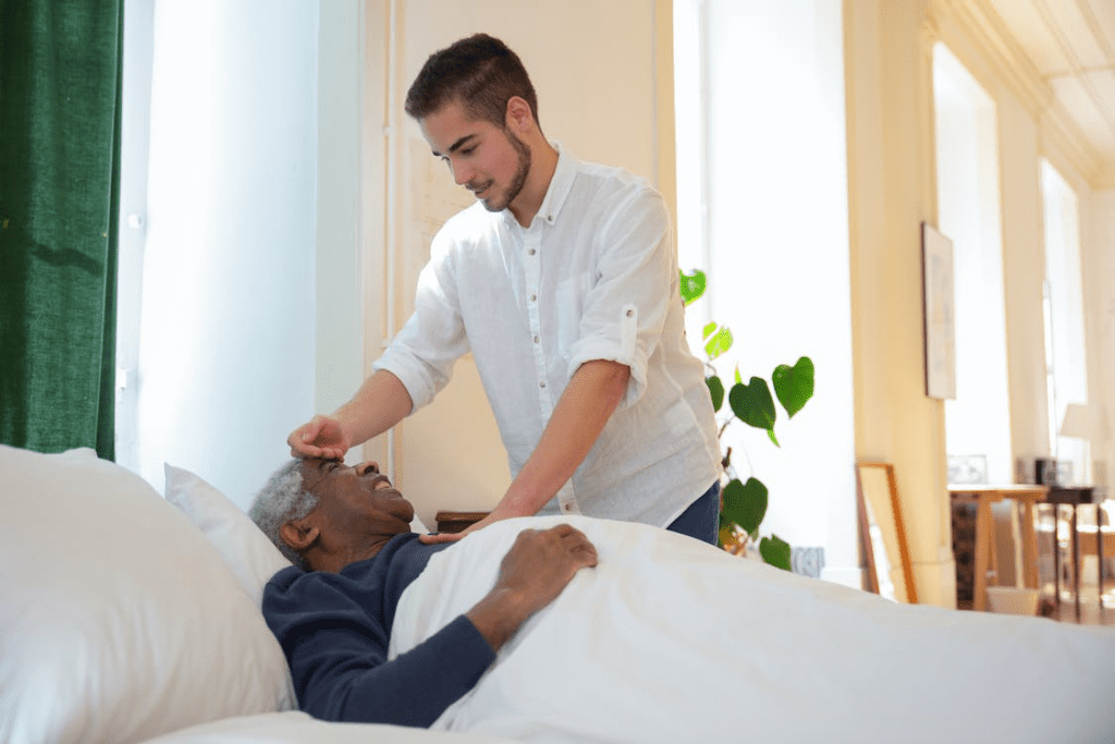 a man on bed with a nurse near him