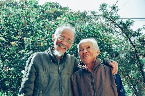 an elderly couple smiling