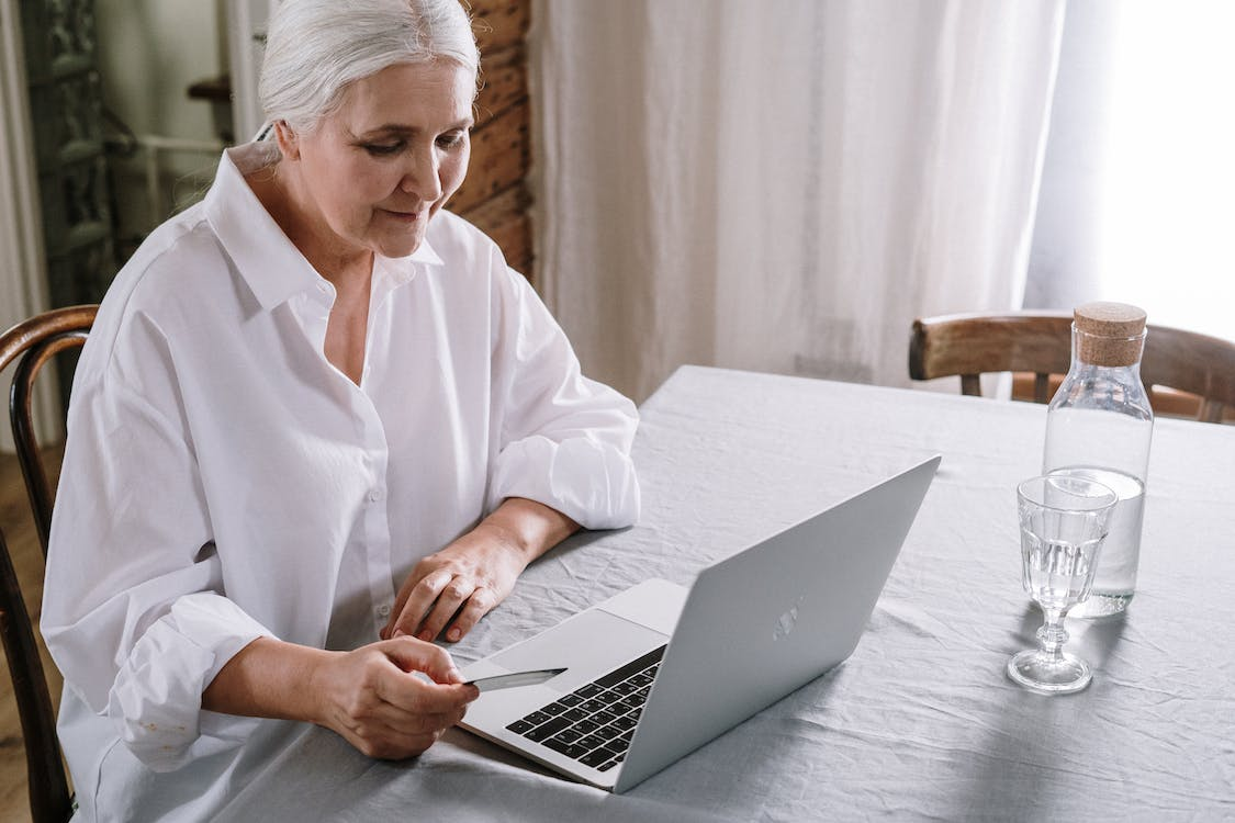  An elderly woman using a laptop