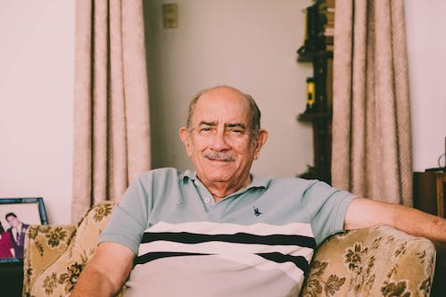 an older adult sitting on a sofa