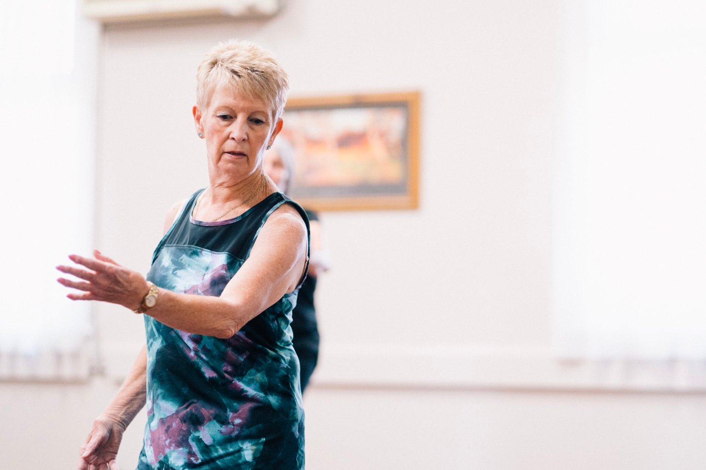  An older woman enjoys working out with help from a caregiver’s home healthcare.