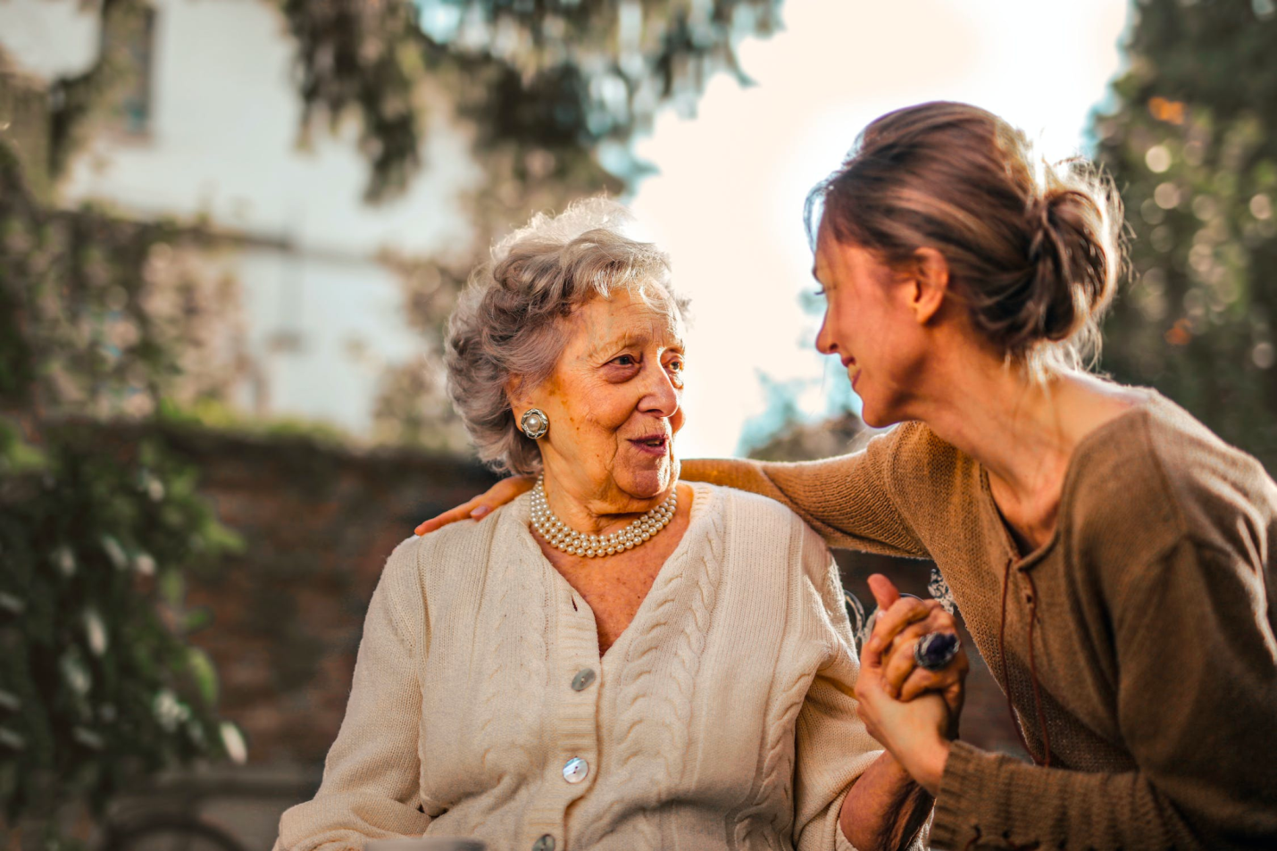 An at-home caregiver offers support to an aging senior. 